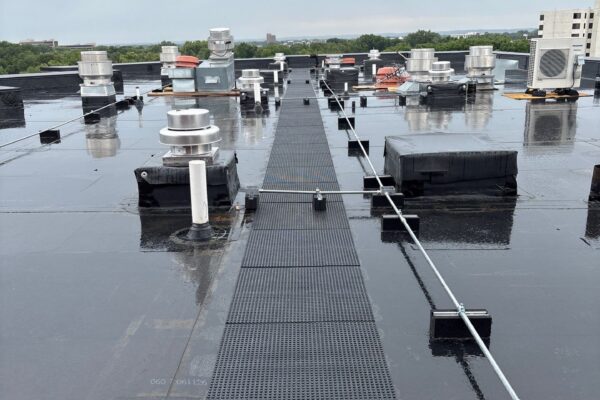 EPDM flat roofing system with protective walk pads on an apartment building in Edina, Minnesota, installed by Rayco Construction